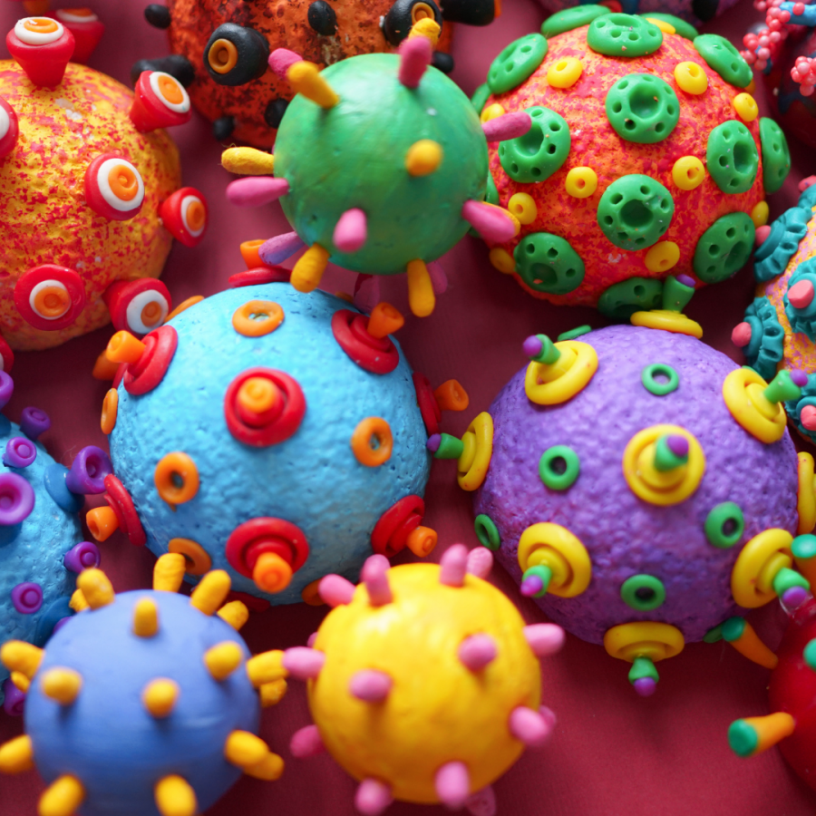 Picture provided by Canva. Model of COVID-19 virus under microscopic view.