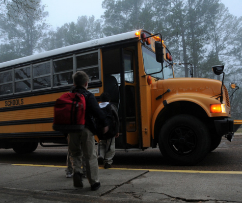 Kids get onto a bus, similar to the kind that Farmington School District uses.