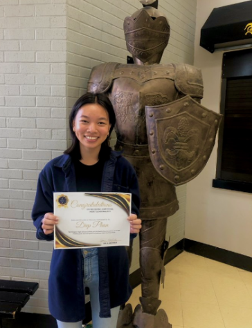 Diep with her certificate after receiving her scholarship at the FHS front lobby