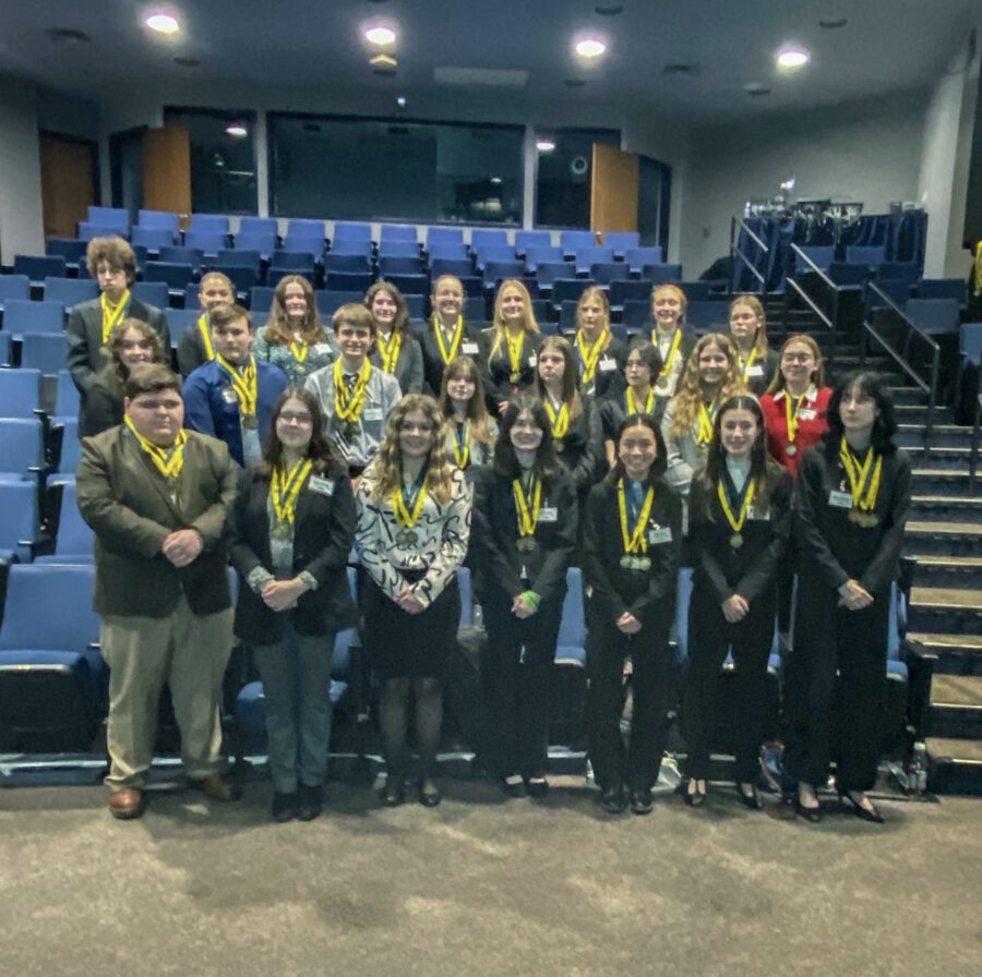Members+of+FBLA+gather+for+a+group+photo+wearing+their+hard-earned+gold+medals.