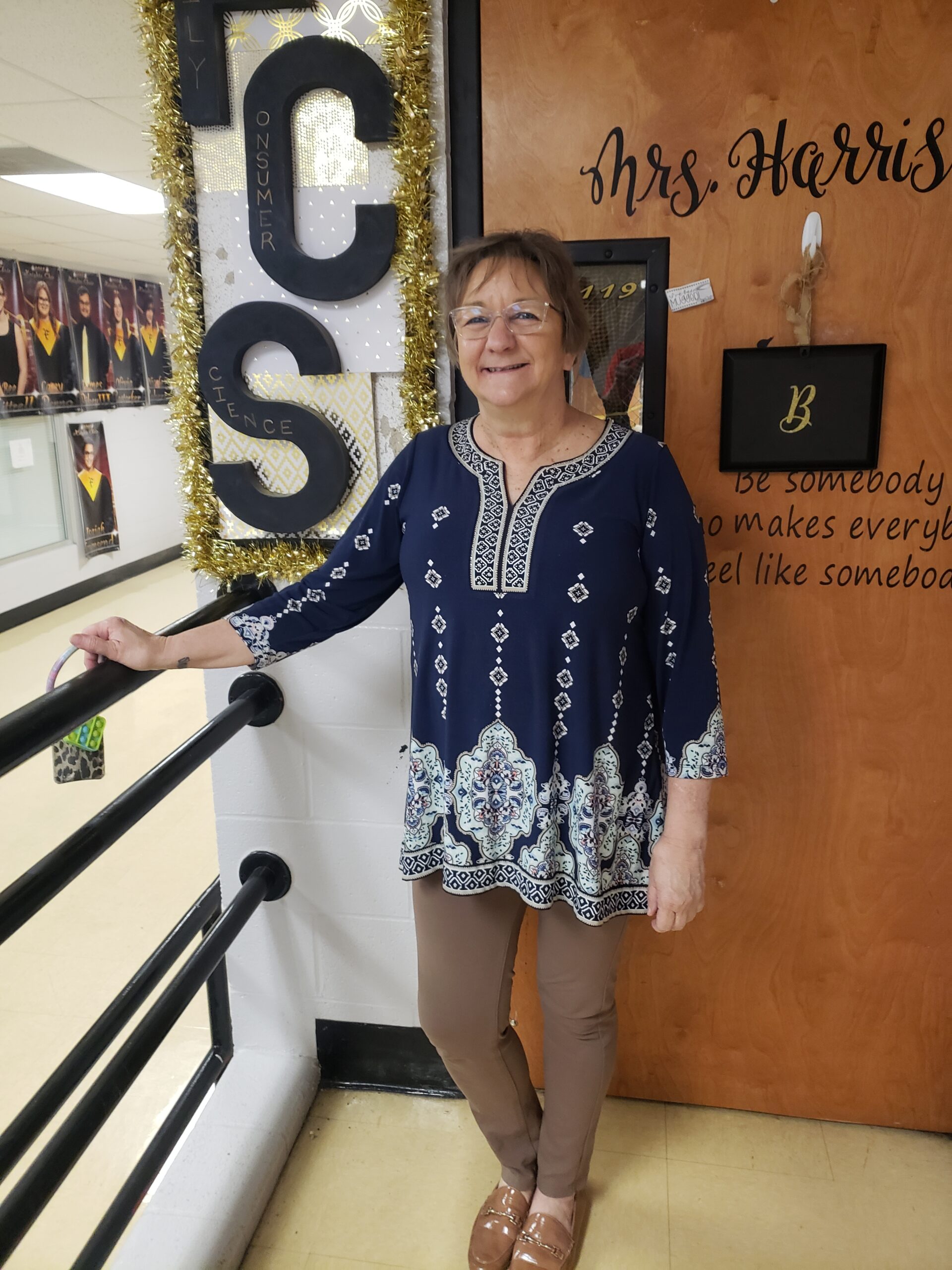 Mrs. Harris and her infectious smile outside her room in Senior Hall.