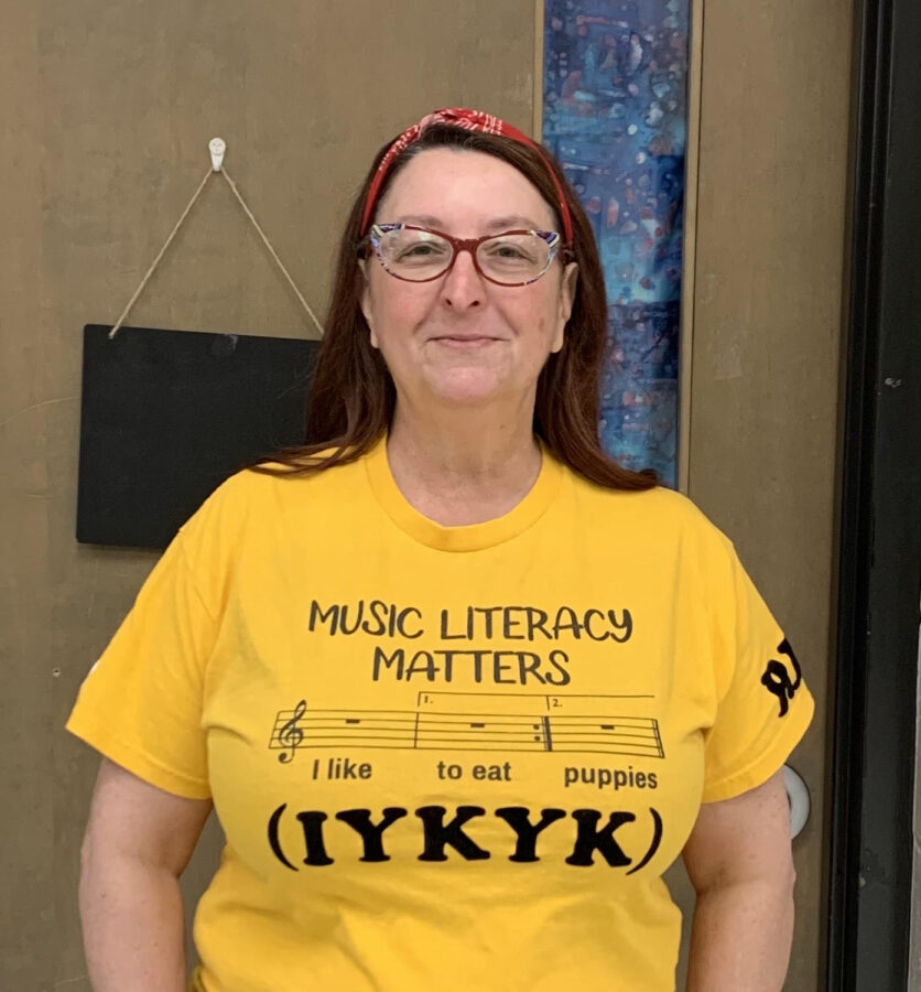 Mrs. Regina Brown-Vaughn smiles for the camera, wearing a clever t-shirt about music literacy.