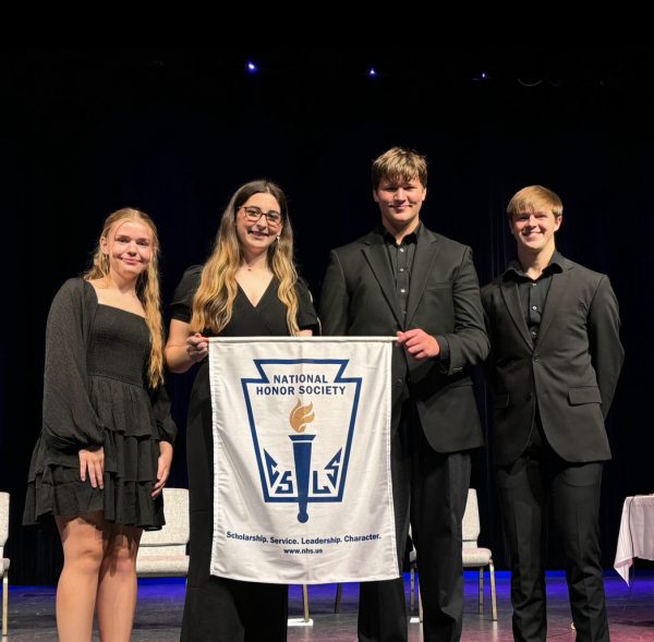 Here, the officers of the FHS National Honor Society, Secretary Alaina Pulliam (far left), President Ava Obenauer (left center), Vice President Alex Cummings (right center), and Treasurer/Public Relations Director Noah Brennon, gather for a group photo following the 2024 NHS induction ceremony. 