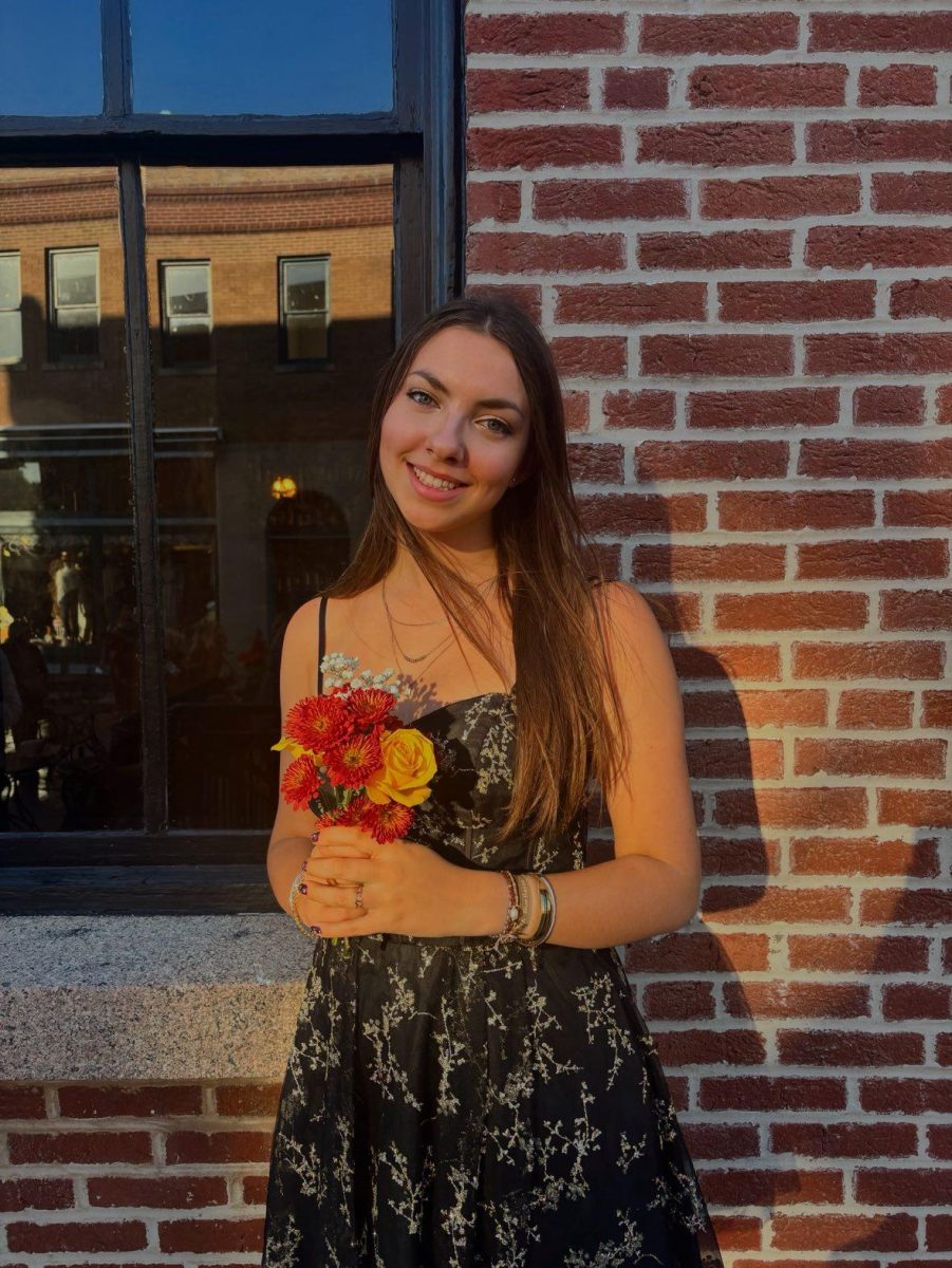 Amelie takes a picture in downtown Farmington before the Homecoming Dance.